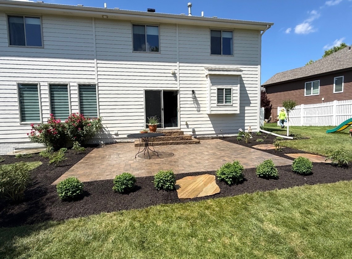 Backyard paver patio with landscape beds